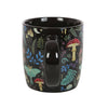 Black mug with colorful forest pattern on a white background
