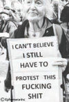 Person holding a sign with protest message in a crowd