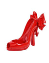 Red high-heeled shoe with a large bow on a white background