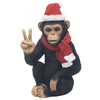 Chimpanzee figurine wearing a Santa hat and scarf on a white background