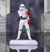 Stormtrooper figure with red boxing gloves on a reflective surface