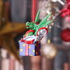 Decorative ornament with a green dragon on a gift box against a blurred festive background