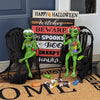 Two green alien figurines with Halloween decorations and a 'Happy Halloween' sign.