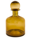 Amber glass bottle with a spherical stopper on a white background