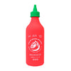 Red sauce bottle with green cap on a white background