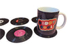 Mug with 'Daddy Cool' design on a pink surface with vinyl records.