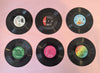 Six vinyl records with colorful labels 